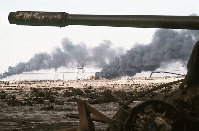 n     A Kuwaiti oil field set afire by retreating Iraqi troops burns in the distance beyond an abandoned Iraqi T-55A tank following Operation Desert Storm. (1991) Photo: JO1 Gawlowicz. Source: DefenseImagery http://www.defenseimagery.mil/imagery.html#guid=cfb81c60059765e70b93e2cc4015383f810a0bfc. Via Wikimedia Commons http://commons.wikimedia.org/wiki/File:Disabled_Iraqi_T-54A,_T-55,_Type_59_or_Type_69_tank_and_burning_Kuwaiti_oil_field.jpg 