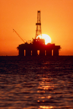 Oil drilling platform at sunset