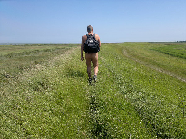 Walking along the coast. ("Naturism is liberating and its legal,this photo promotes and enhances all the freedoms of walking naked on a hot sunny day"). By theactivistuk (2014).