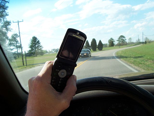 Person using cell phone while driving. (2007)