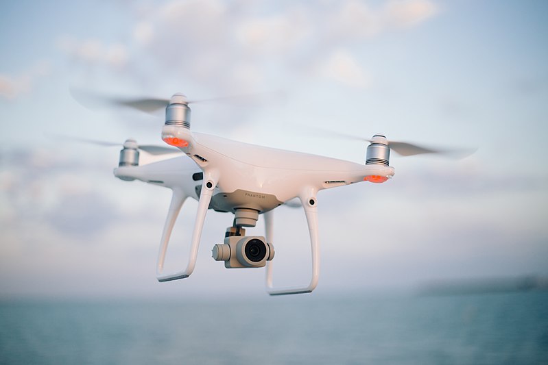 A quadcopter camera drone in flight.
