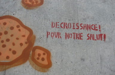 Degrowth graffiti on a wall in Neuchâtel.