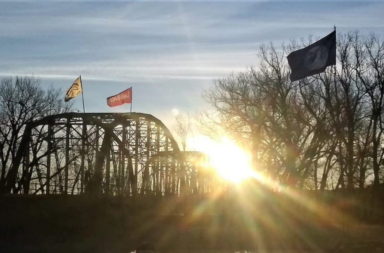 Landback flags on bridge
