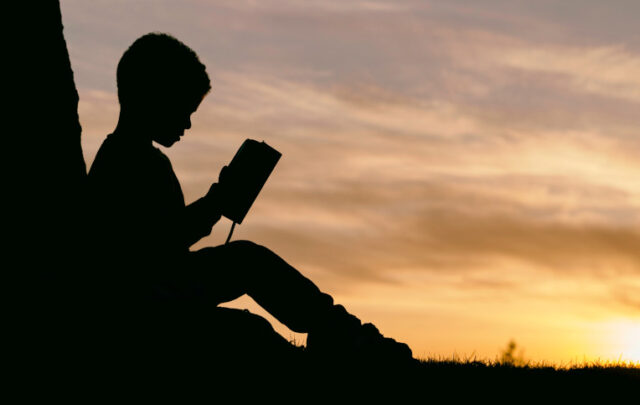 child reading outdoors