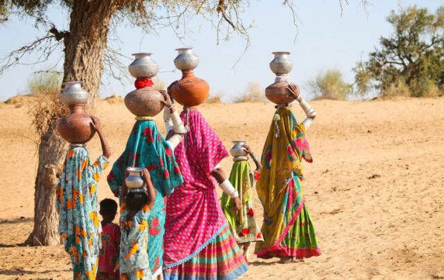 Women head-carrying water