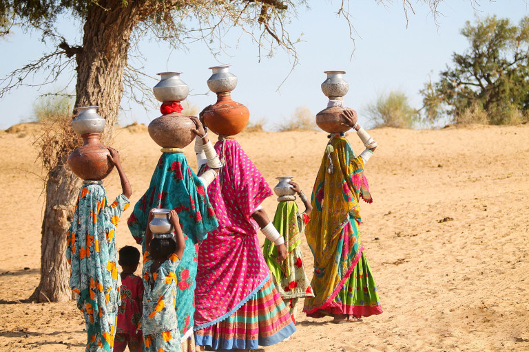 Women head-carrying water