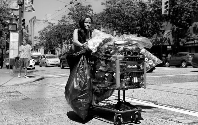 homeless woman with shopping cart