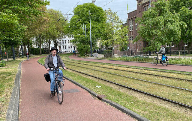 Rick Steves biking through Amsterdam