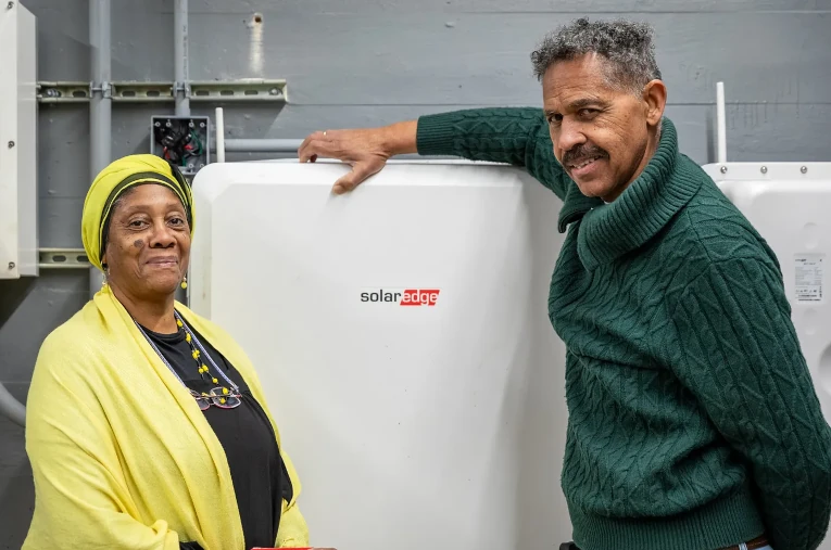 Queen Shabazz (left) with solar power + storage system at the Resiliency Hub