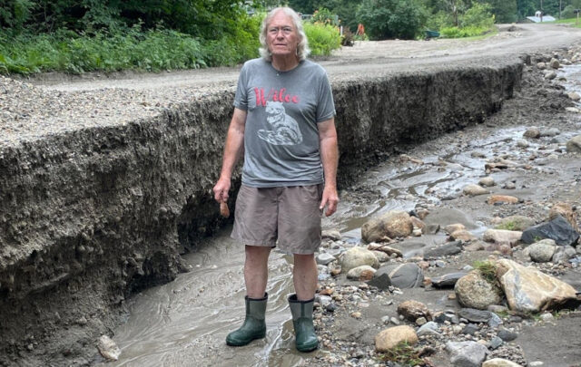 Erin's grandfather standing in a flooded ditch