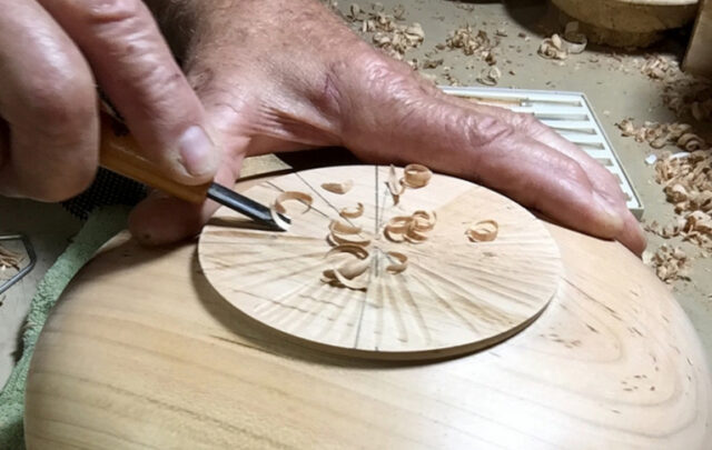 Tom Goldschmid working a wooden bowl by hand.