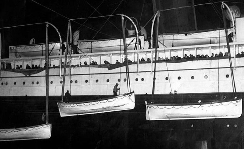 Lifeboats from the RMS Titanic are uploaded to the RMS Carpathia in the hours after the sinking (1912).