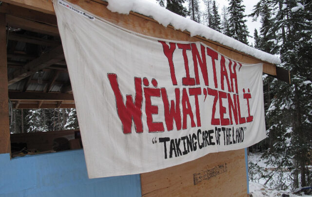 A banner at Unistʼotʼen camp in 2012