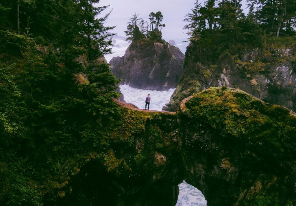 Person standing over a waterfall.