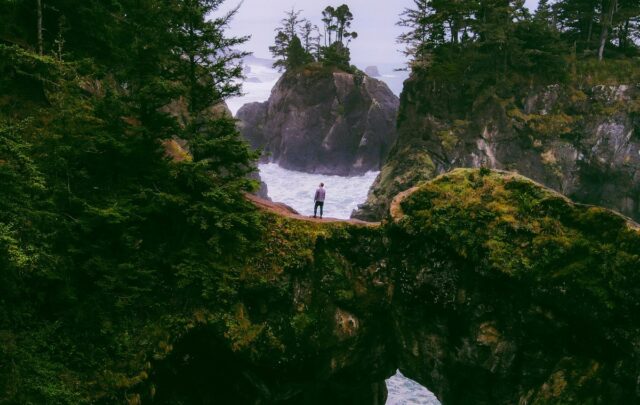 Person standing over a waterfall.