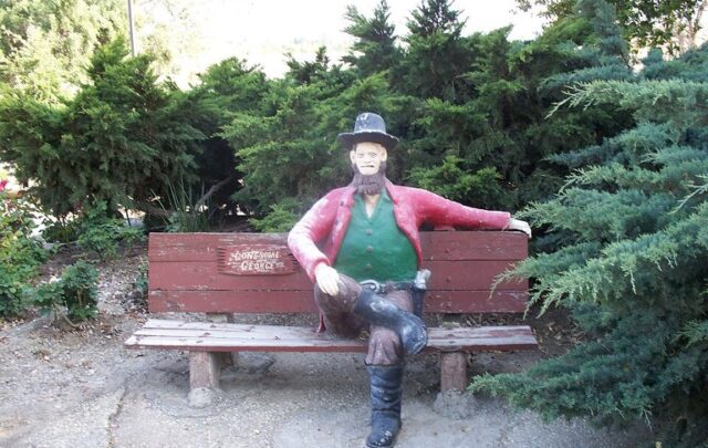 Statue of an old man on a bench built by an aged visionary named John Ehn, a classic victim of dementia concretia.